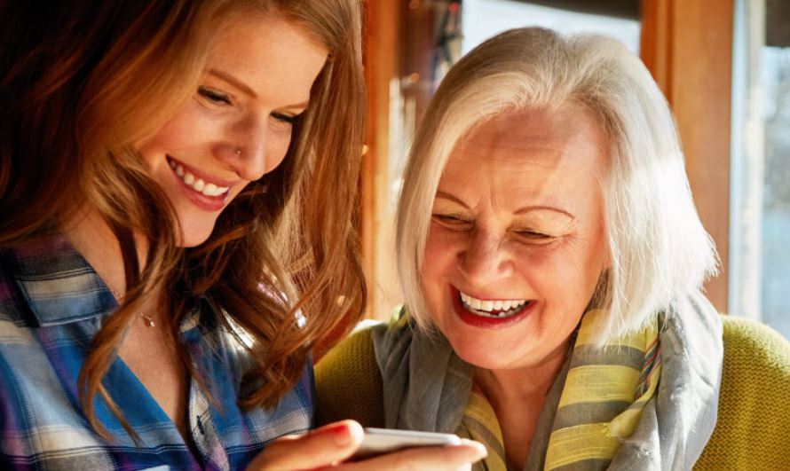 Two women looking at cell phone screen