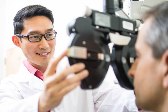 An eye doctor examining a patient.