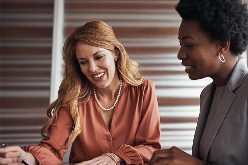 Two businesswomen reviewing documents.