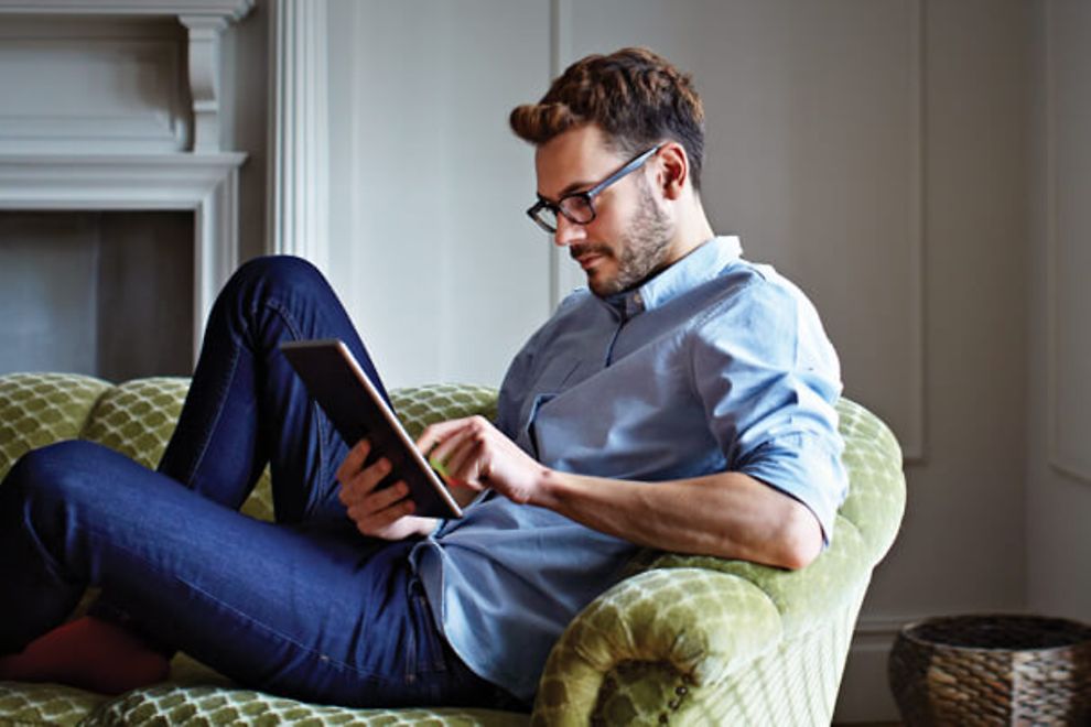 Man using a tablet on a couch