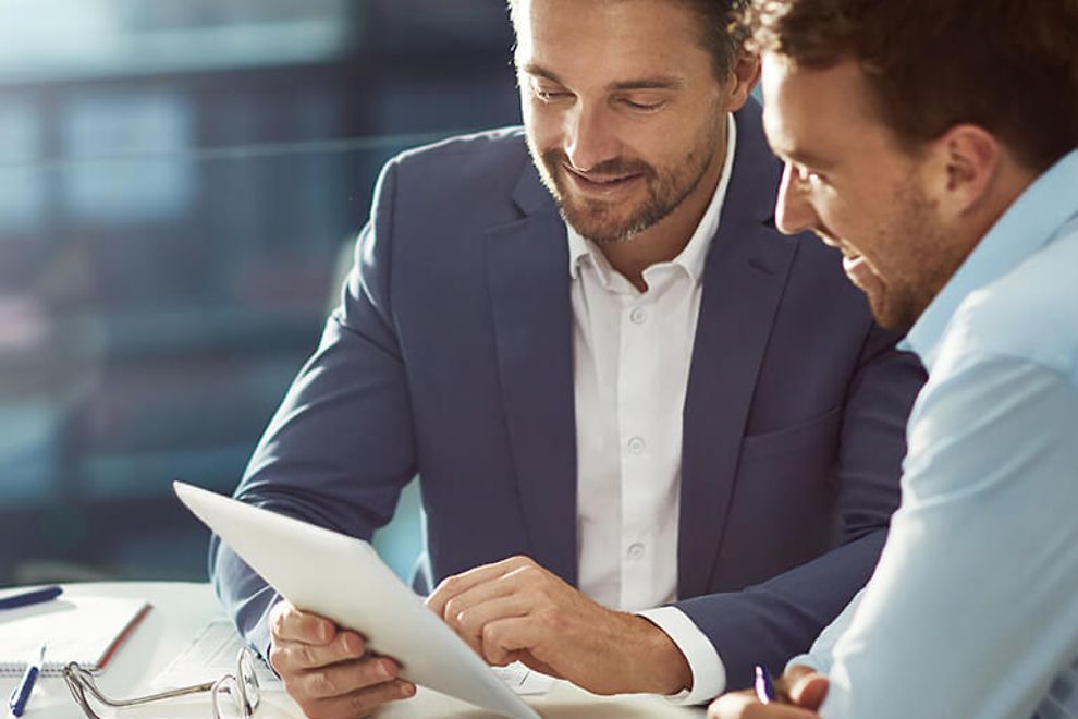 Two businessmen looking at a tablet