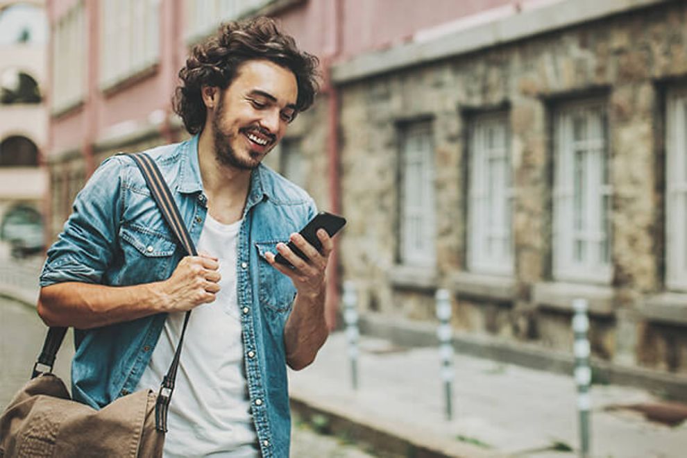 Man looking at his phone in a city environment