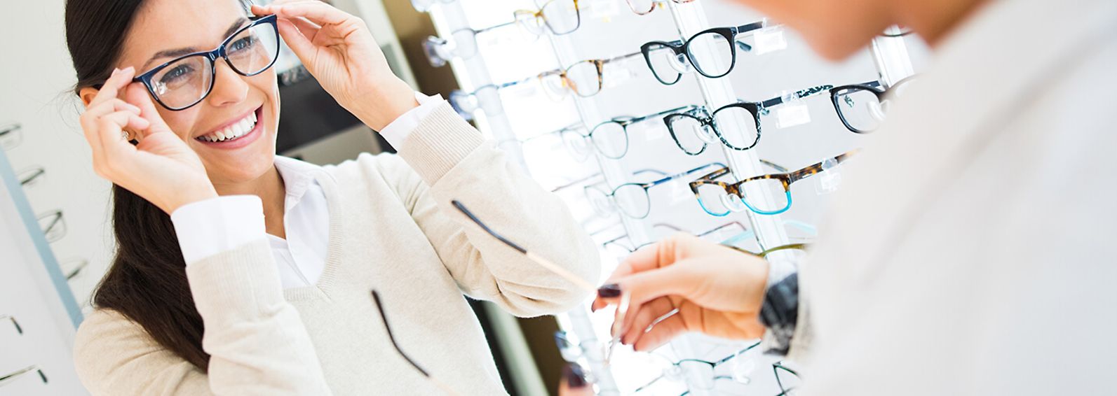 woman trying on glasses in an eye doctor's office