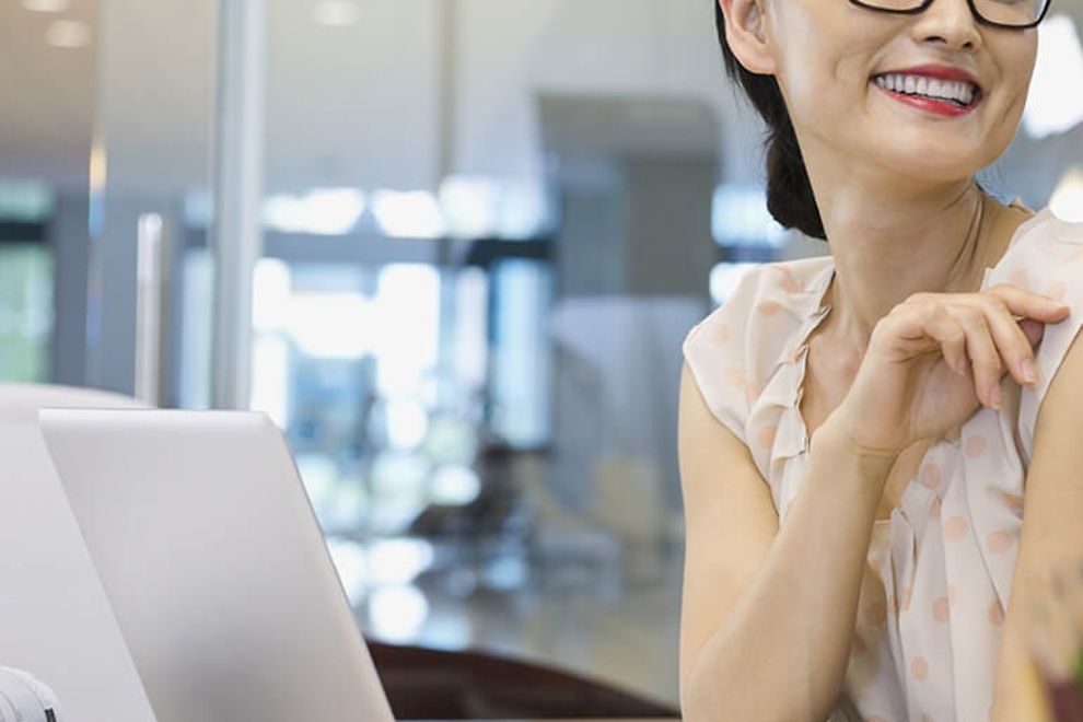 You woman using a computer in an office.