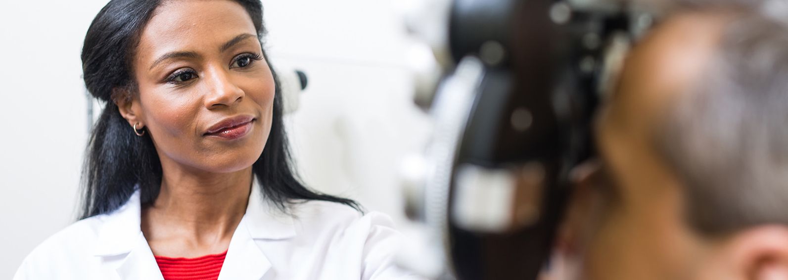 An optometrist examining a patient's eyes.