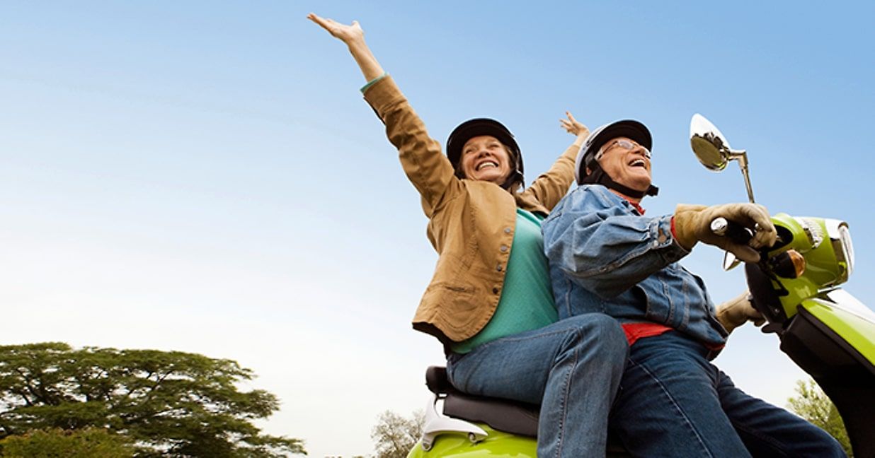 senior couple riding on scooter